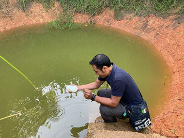 Hector Castelan collecting a water sample